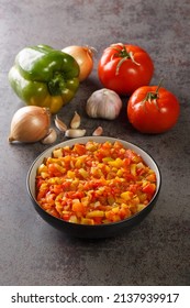 Mediterranean Sofrito Sauce From Ripe Peppers, Tomatoes, Garlic And Onions Close-up In A Plate On The Table. Vertical
