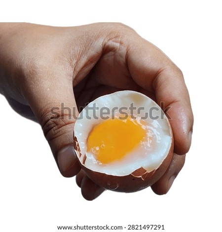 Medium boiled egg. Soft-boiled egg isolated on a white background. A hand holding a boiled egg.