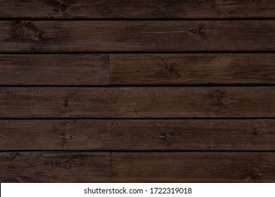 Medium Brown Wood Texture Background Viewed From Above. The Wooden Planks Are Stacked Horizontally And Have A Worn Look.