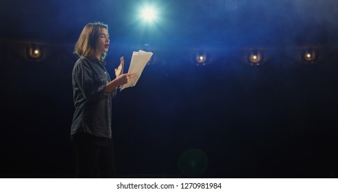 Medium close-up of an actress rehearsing a monologue in a theater while holding her script