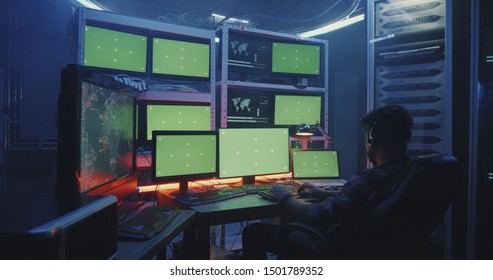 Medium Close-up Of A Hacker Spreading Computer Virus With Green Screen Multiple Monitors