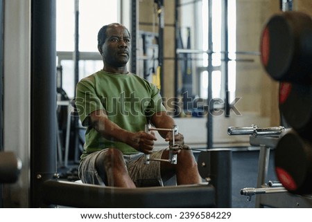 Medium full shot of elderly african american sportsman doing abs exercise at gym sitting on bench