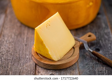 Medium Hard Cheese Head Edam Gouda Parmesan On Wooden Board With Knife Wooden Texture Daylight Side View