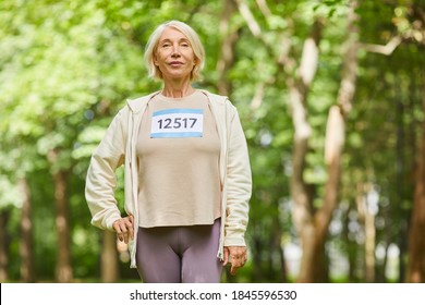 Medium Portrait Shot Of Beautiful Caucasian Senior Woman Taking Part In Summer Marathon Looking At Camera, Copy Space