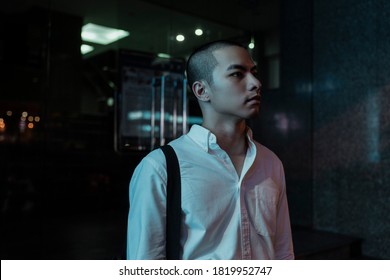 Medium Portrait Shot Of Skinhead Man In White Shirt Standing In The Light.