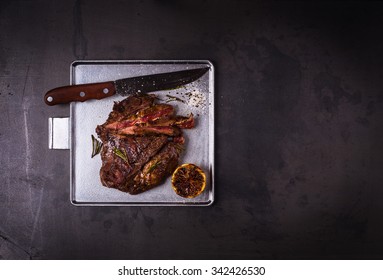 Medium Rare Grilled Marinated Beef Flank Steak On Silver Plate With Copy Space, Top View