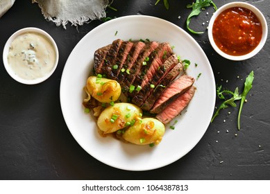 Medium Rare Roast Beef With Potato Over Black Stone Background. Top View, Flat Lay