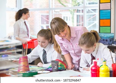 Medium Shot Of An Art Teacher Watching Middle School Students Paint During An Art Class.