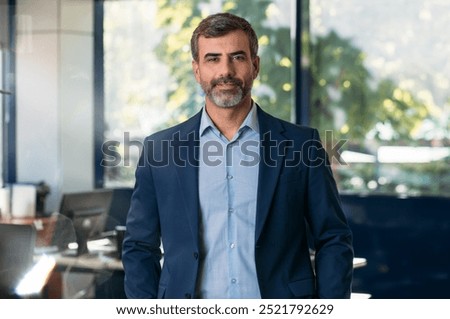 Medium shot of businessman looking at camera in office