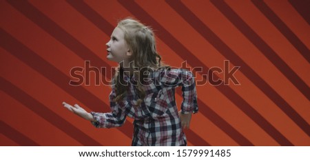 Medium shot of a child actress acting a scene in a musical
