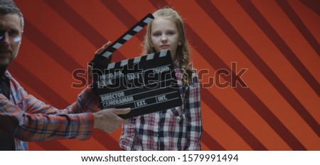 Medium shot of a child actress acting ending scene of film during film shooting