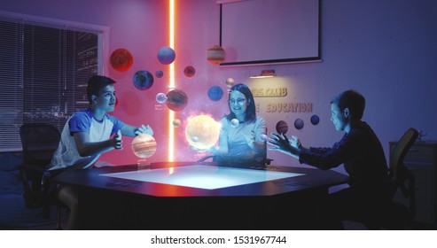 Medium shot of children playing with holographic solar system