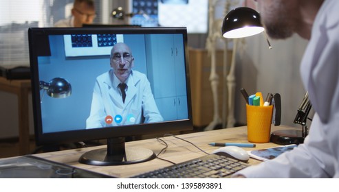 Medium Shot Of Doctors Discussing MRI Scan Results During A Video Call