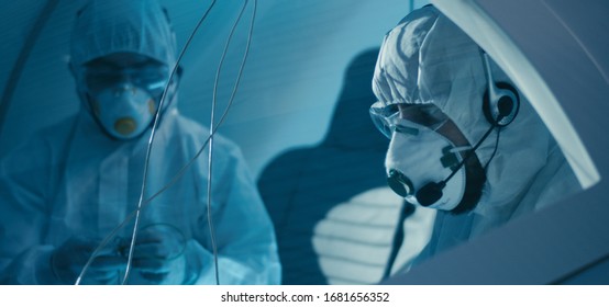 Medium shot of engineers assembling cockpit in clean room