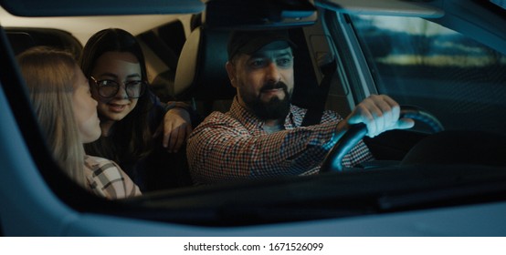 Medium Shot Of Family Chatting And Traveling By Car At Night