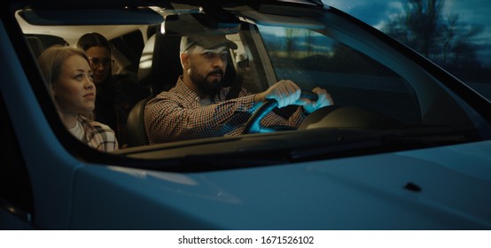 Medium Shot Of Family Chatting And Traveling By Car At Night