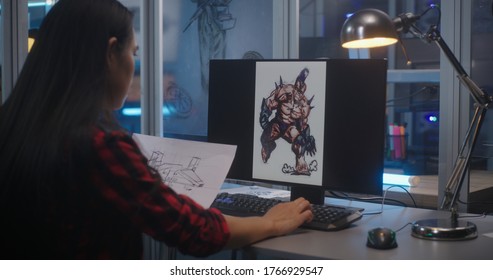 Medium Shot Of A Female Graphic Designer Sorting Concept Art For Video Game