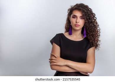 Medium shot feminine modern young woman with elegant look professional makeup and glamour jewellery crossed her arms over her chest. Female model looking at camera - Shutterstock ID 2157535545
