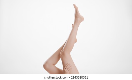 Medium shot of flawless female legs on white background | Unwanted hair removal and leg care concept