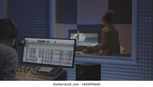 Medium Shot Of Foley Artist And Sound Engineer Working In Studio