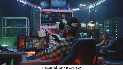 Medium shot of a hacker using VR gloves and headset