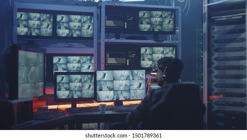 Medium Shot Of A Hacker Watching Hacked Security Camera Footage