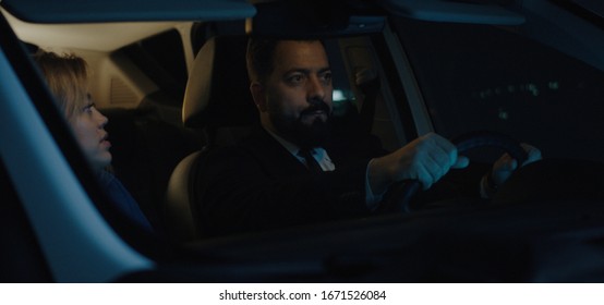 Medium Shot Of Happy Couple Traveling In Car And Chatting At Night