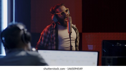 Medium Shot Of A Male Actor Doing Voice Over In A Sound Studio