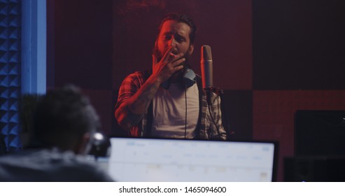 Medium Shot Of A Male Actor Doing Voice Over In A Sound Studio