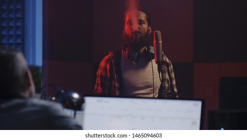 Medium Shot Of A Male Actor Doing Voice Over In A Sound Studio