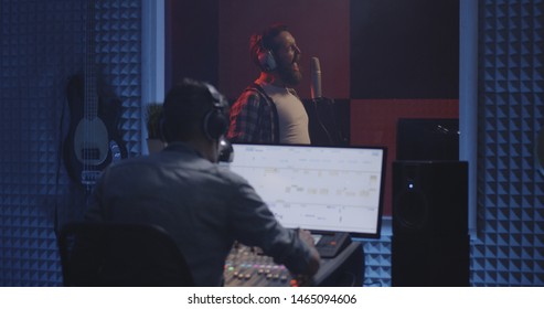 Medium Shot Of A Male Actor Doing Voice Over In A Sound Studio