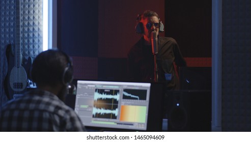 Medium Shot Of A Male Actor Doing Voice Over In A Sound Studio