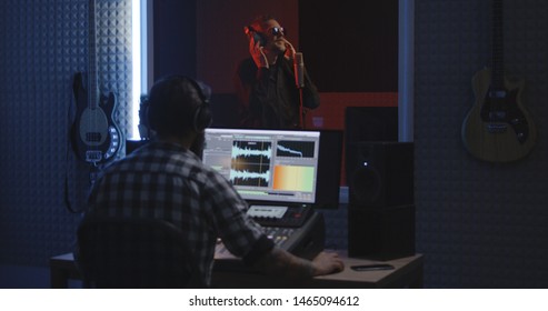 Medium Shot Of A Male Actor Doing Voice Over In A Sound Studio