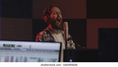 Medium Shot Of A Male Actor Doing Voice Over In A Sound Studio