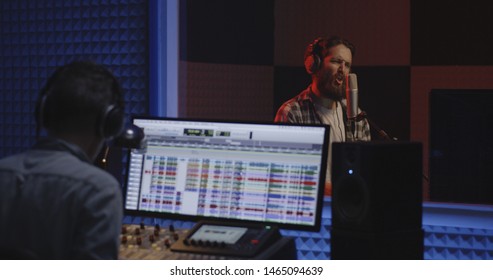 Medium Shot Of A Male Actor Doing Voice Over In A Sound Studio