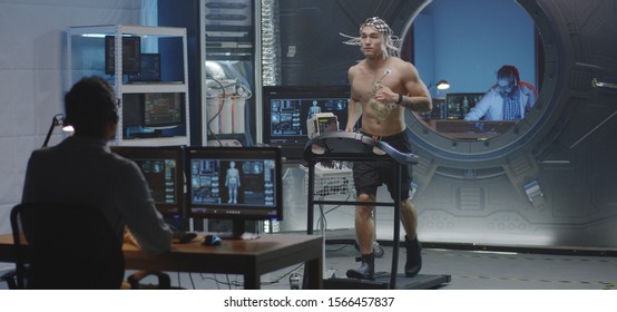 Medium Shot Of A Male Astronaut Running On A Treadmill During A Pre-flight Test