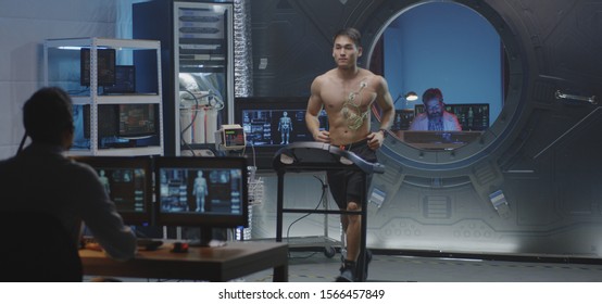 Medium Shot Of A Male Astronaut Running On A Treadmill During A Pre-flight Test