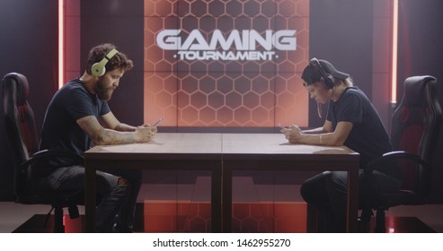 Medium Shot Of A Man And Woman Competing At A Mobile Gaming Tournament