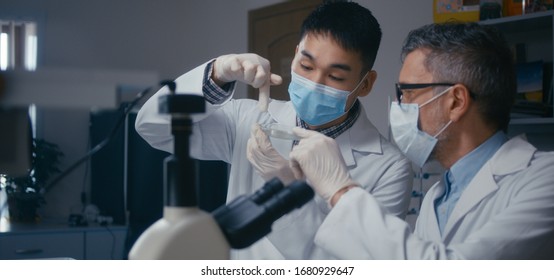 Medium shot of professor and student discussing in laboratory - Powered by Shutterstock