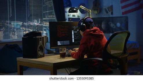 Medium Shot Of A Programmer Coding On His Computer At Night