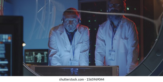Medium shot of scientists discussing while conducting a test in a laboratory
