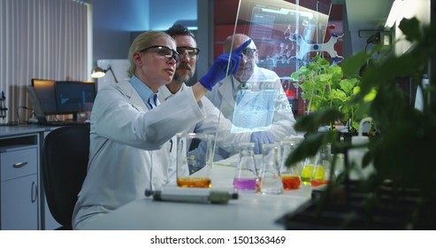 Medium shot of scientists using a holographic display screen