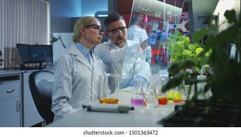 Medium shot of scientists using a holographic display screen