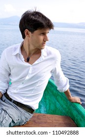 Medium shot of serious good looking man on green boat