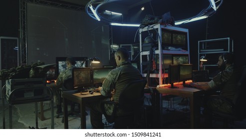 Medium Shot Of A Soldier Pointing A Handgun At His Comrades During Rocket Launch In A Military Base