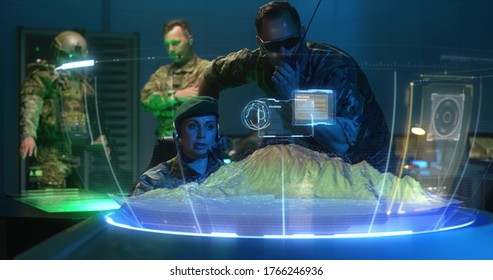 Medium Shot Of Soldiers Discussing Military Strategy With Holographic Landscape Display