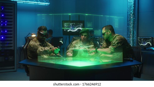 Medium Shot Of Soldiers Remote Controlling A Combat Drone In A Military Base Using Futuristic Holographic Table Technology