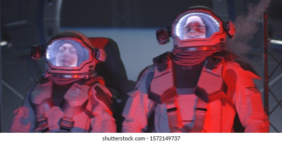 Medium Shot Of Two Astronauts Experiencing Increased G Force In Accelerating Spaceship