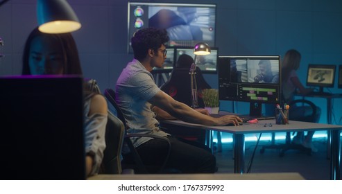 Medium Shot Of Video Editors Working At Their Workstation