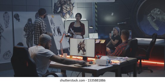 Medium shot of a video game developer team brainstorming - Powered by Shutterstock